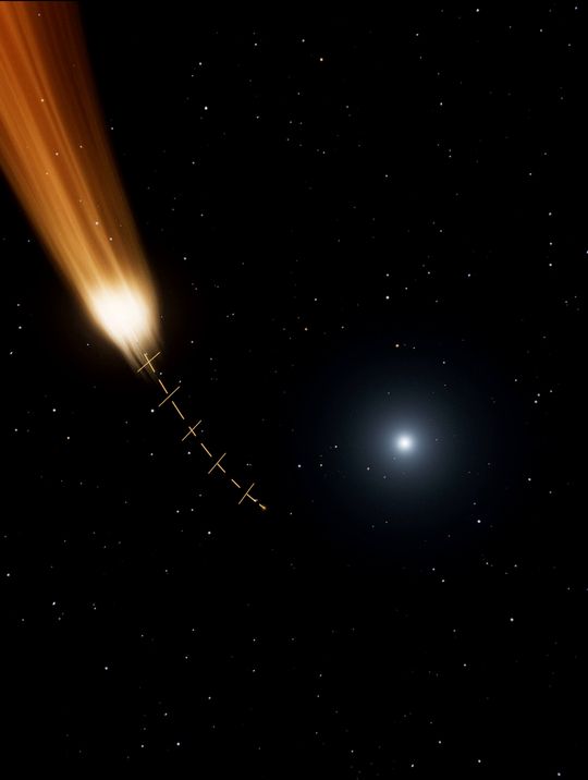 A plume of stolen gas falls along a dashed gold arc toward the dwarf