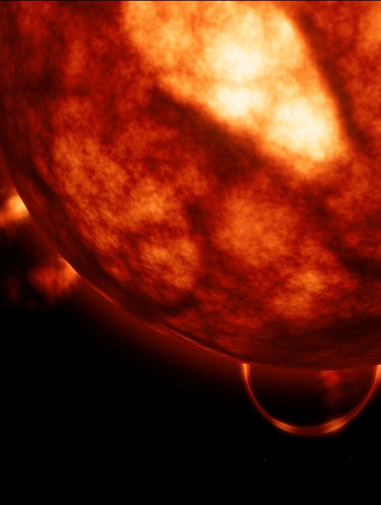 Goliath: the red giant's boiling surface fills the frame, a prominence loop arching from its limb